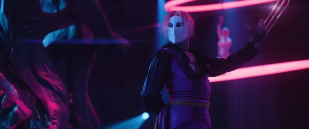 A masked fighter in a neon-lit arena, from the official Street Fighter trailer